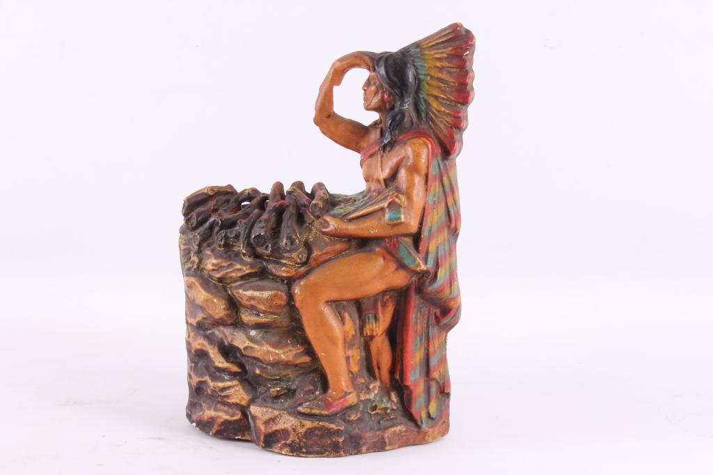 Art Deco Style Indian Chief & Campfire Lamp: This lot includes a vintage 1930's art deco style chalk ware radio or table lamp with a Native American Indian chief on the front and tin lighting compartment on the back. Inside the back compartment 