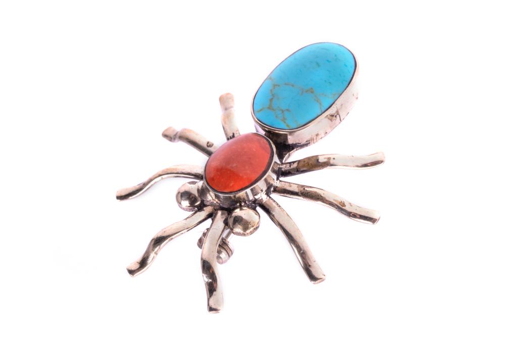 Armand American Horse Silver Turquoise & Coral Pin: Featured in this lot is this alpaca silver, cripple creek turquoise and red branch coral spider pin from Lakota artist Armand American Horse circa (1982 -). The pin shows a spider design with alpaca s