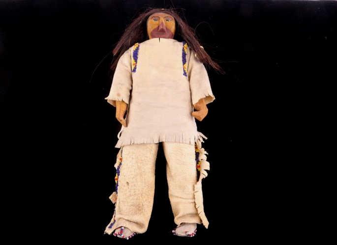 Eastern Plains Indians Wood Carved Hide Doll 1900-: Featured in this lot is this Eastern Plains Indians wood carved hide doll, circa early-to-mid 1900's. The doll shows a wonderfully crafted wood carved construction with naturally tanned hide and trade