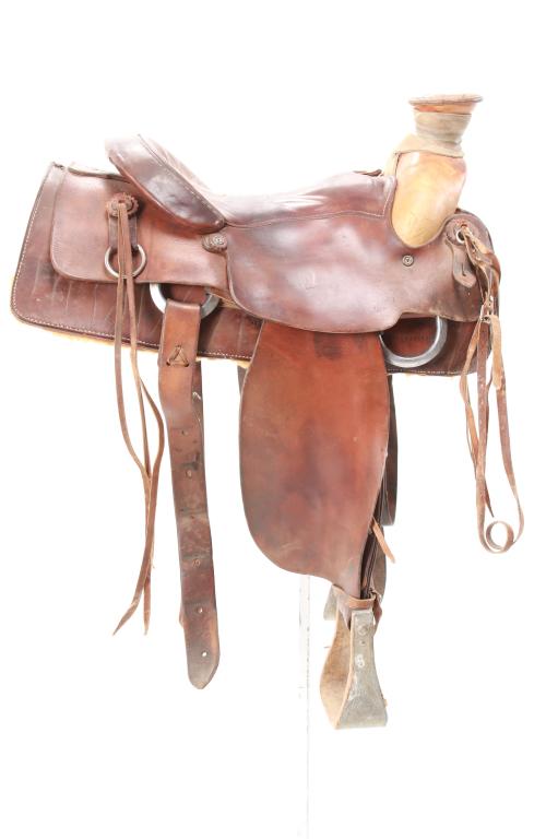 Mexican Traditional Charro Saddle c. 1950's: Featured in this lot is this Mexican Charro saddle circa mid-to-late 1900's. The saddle features a traditional Charro design with an exposed seat and under gallery of straps. The horn is 5" and shows 