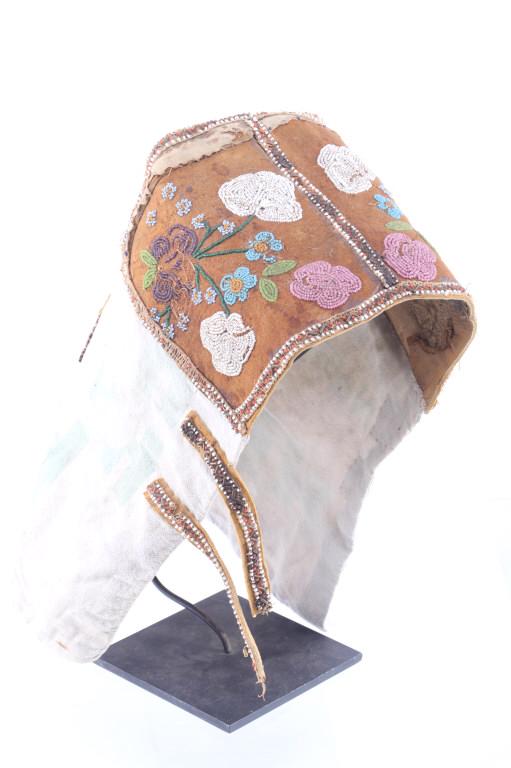Great Lakes Woodland Beaded Cradle Board Cover: Featured in this lot is this Great Lakes Woodland breaded cradle board cover, c. 1900's. The cover shows a wonderfully and professionally constructed design of Nashville Feed bag with Indian tanned hi