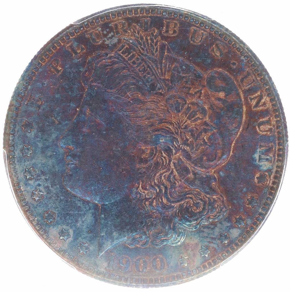 1900 Morgan Silver Dollar PCGS AU Deep Blue Tone: Featured in this lot is this Morgan Silver Dollar, AU(50-60) professionally graded by PCGS circa 1900 with the richest deep blue rainbow tone we have ever seen on a coin. The coin features the iconic 