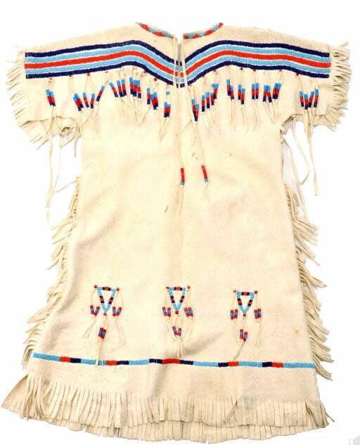 Northern Plains Beaded Dress c. 1950-: This is an excellent Indian tanned hide beaded child’s dress from the Northern Plains Native American Indians dating to the mid-to-late-1900’s. The dress likely originated from the Blackfeet or Cr