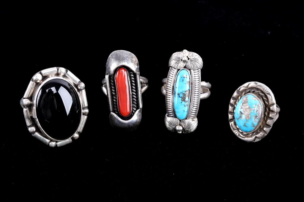 Early Navajo Silver Onyx Turquoise Coral Rings (4): For your consideration in this lot is a collection of four Navajo Native American silver rings with cabochons. The first ring has an Onyx cabochon. The large cabochon measures 1" X 3/4 and has a bar a
