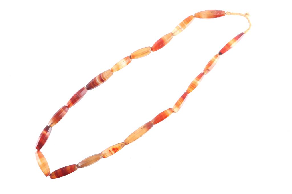 Faceted Carnelian Agate Trade Beads c. 1800: Offered in this lot is a sublime, faceted, antique Brazilian Carnelian Agate bead necklace. Beads like this were cut in Idar-Oberstein, Germany and traded in West Africa in the late 1800s. These agate