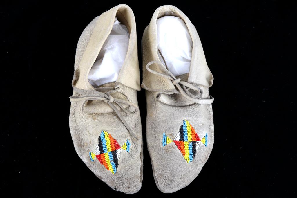 Crow Montana Beaded Moccasins circa 1960's: Featured in this lot is this pair of beaded moccasins from Crow Montana Indians, circa 1960's. The moccasins feature a beautiful Indian tanned hide construction with trade seed beaded toe section. The