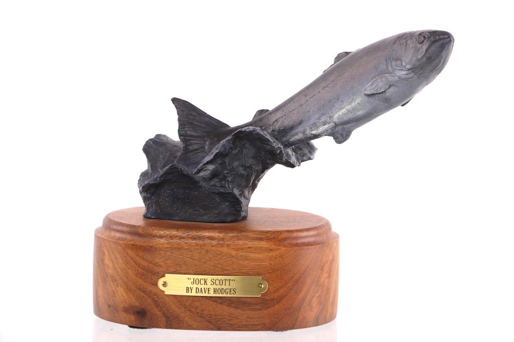 Hodges, Dave (1949 -) "Jock Scottl" Bronze: Featured in this lot is this bronze sculpture called "Jock Scott," from Montana artist Dave Hodges born in 1949. This bronze features a leaping salmon sculpture and features the artist signature on th