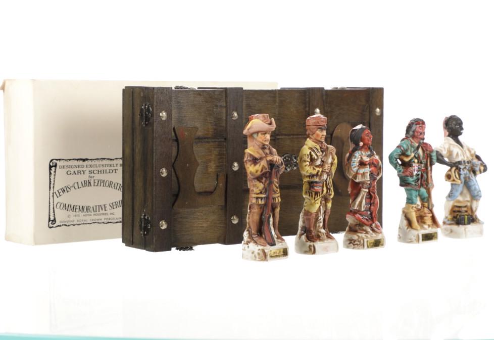 Lewis & Clark Commemorative Decanters By Schildt: This item is a Lewis and Clark Commemorative bourbon decanter set by Gary Schildt and wood display case.This lot features 5 porcelain decanters depicting notable members of the Lewis & Clark explorati