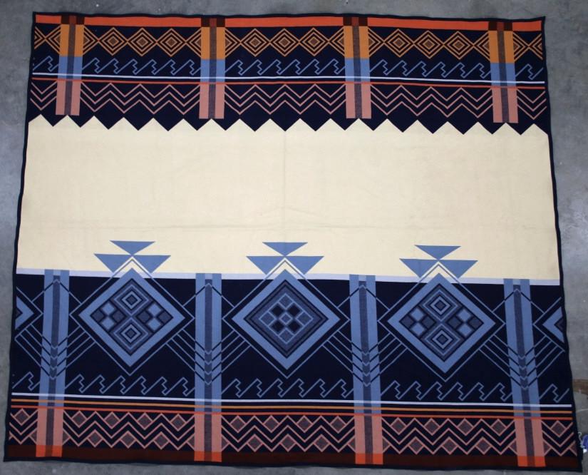 Pendelton The Peaceful Ones Jacquard Blanket: Featured in this lot is this Pendelton "The Peaceful Ones,' Jacquard blanket. The blanket features a lovely wool, cotton and polyester blend with a light blue field with geometric patterns with colora