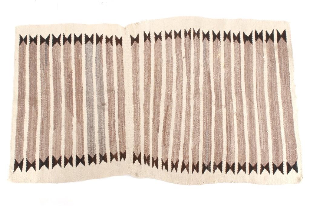 Navajo Stepped Banded Chinle Rug c. 1950's: Featured in this lot is this Navajo stepped banded Chinle rug circa 1950's. The rug features a beautifully crafted Chile design with dark brown stepped decoration of the bands of light brown and all s