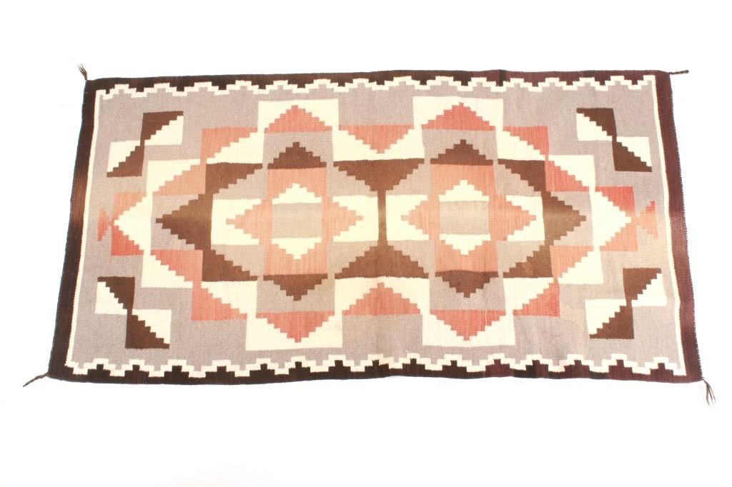 Navajo Two Grey Hills Trading Post Rug c. 1930's: Featured in this lot is this Navajo Two Grey Hills trading post rug circa 1930's. The rug shows a wonderfully and professionally hand woven construction with a black border and grey field with a large