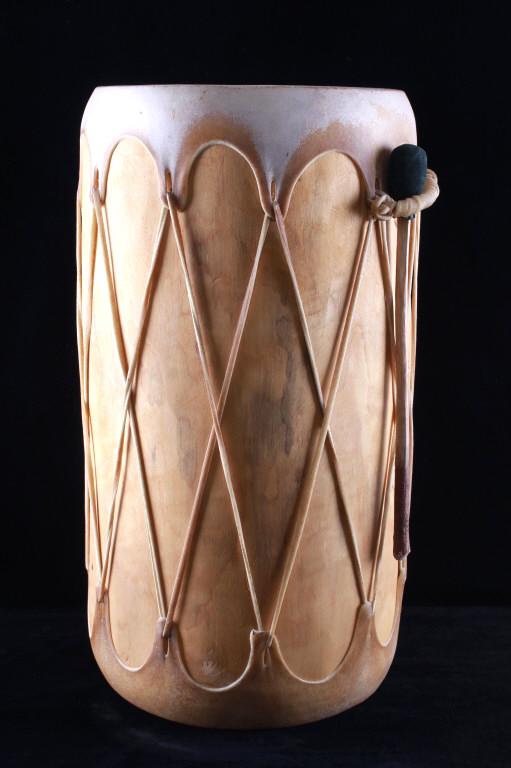 Taos Single Log Rawhide Wrapped Drum: Featured in this lot is this Taos single log rawhide wrapped drum and beater. The drum features a wonderfully and professionally crafted single log construction to the frame and shows rawhide wrapped