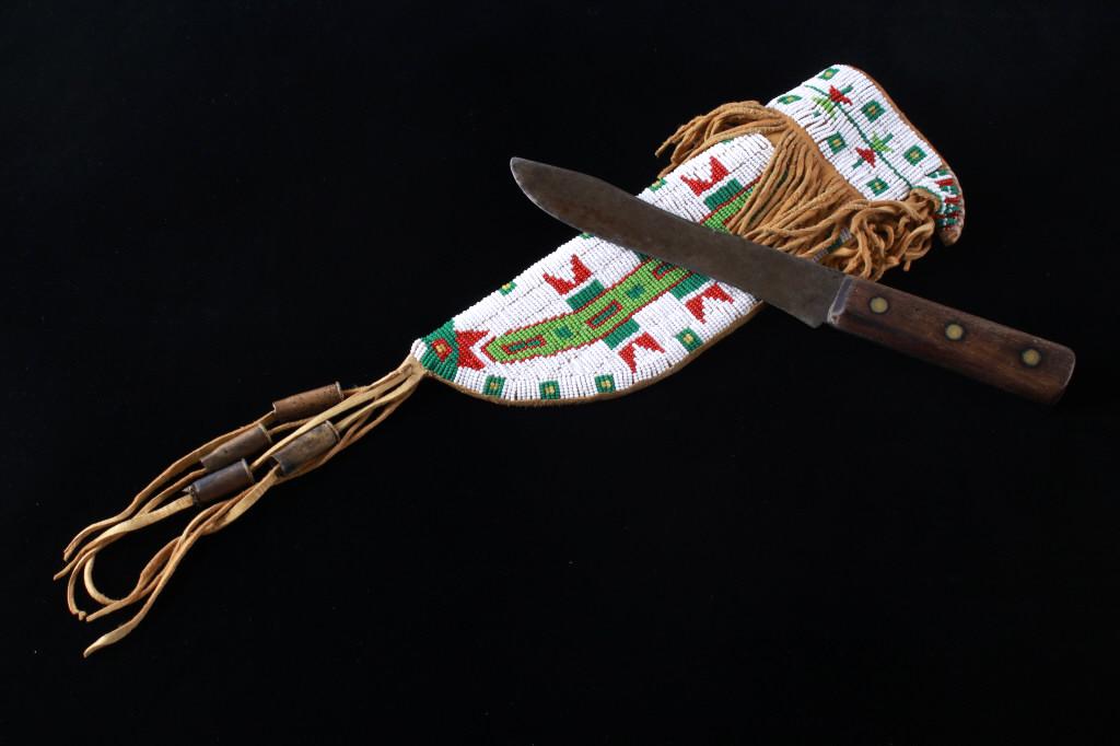 Sioux Beaded Sheath 20th C. & 19th C. Trade Knife: The lot features a mid-to-late 20th Century beaded sheath from the Sioux Indians paired with an old late 19th Century Indian Trade Knife. The knife features a Buffalo Skinner pattern with sharp blade