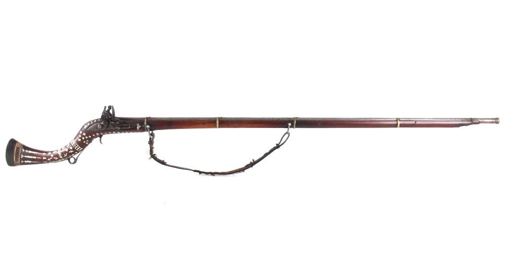 1811 Middle Eastern Pearl Inlayed Camel Musket: Featured in this lot we have a 1811 Middle Eastern percussion cap and ball camel rifle inlayed with mother of pearl and chambered in .54 gauge. The musket displays a 49" long round barrel heavy iron b