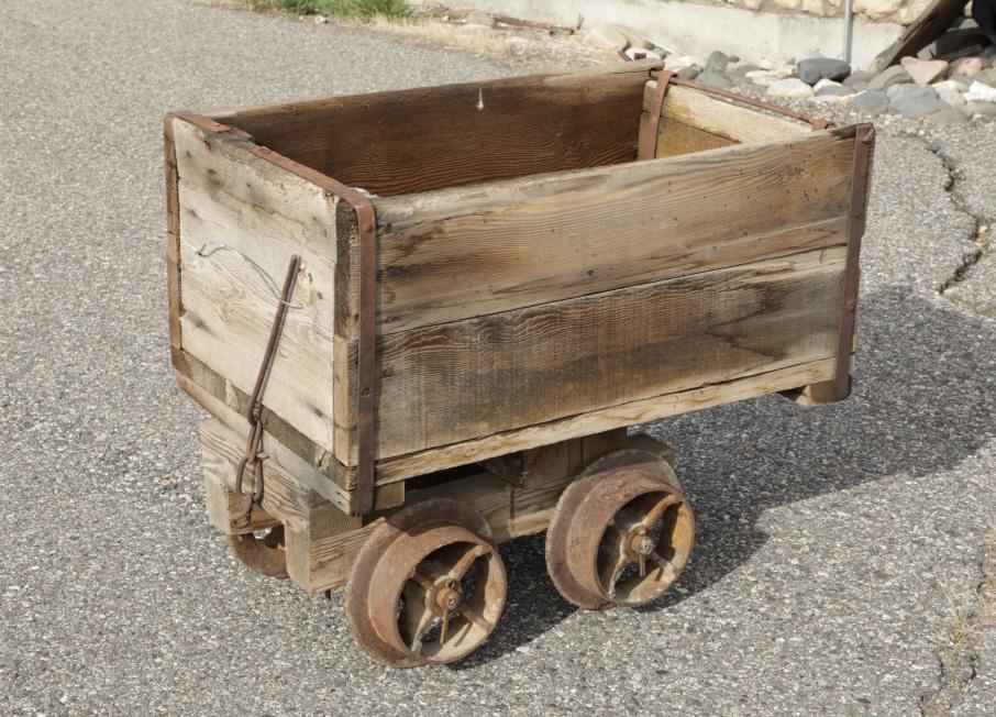 1800's Montana Gold Mine Transport Wood Cart: Featured in this lot we have a Montana gold mine wood transport cart originating from the 1800's. The piece displays solid wood construction with iron reinforcement and construction across the corners