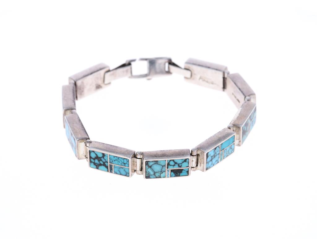M. Kabotie Lomawywesa (Hopi, 1942-2009) Bracelet: Featured in this lot is a Michael Kabotie Lomawywesa (Hopi, 1942-2009) sterling silver inlaid Number 8 Turquoise bracelet circa 1970-1990s. The bracelet shows a combination of his documented "K" hallm