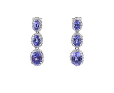 6.55ct Tanzanite Diamond & 14k Gold Earrings: Featured in this lot is this 6.55ct tanzanite diamond and 14k gold earrings with GGA paperwork. The earrings feature a wonderfully and professionally crafted a 14k white gold construction. The