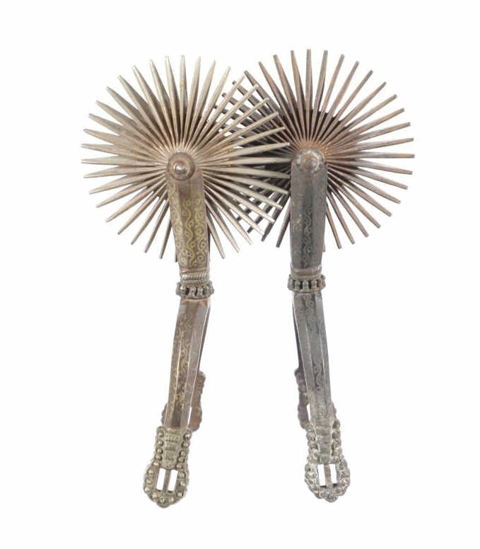 Argentinean Etched LARGE Rowel Spurs c. 1880-1910: Featured in this lot is this Argentinean etched LARGE rowel spurs circa 1880-1910. The spurs features a wonderfully and professionally crafted stainless steel and gold gilt construction that shows som