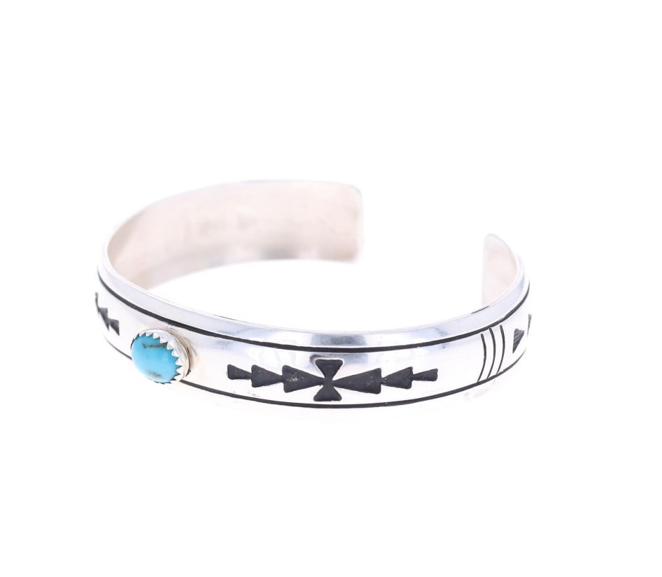Navajo Singer Sterling Silver Turquoise Bracelet: Featured in this lot we have a T & R Singer Navajo sterling silver and turquoise bracelet. The bracelet was artfully crafted by T & R Singer showing wonderful sterling silver construction with a caboc
