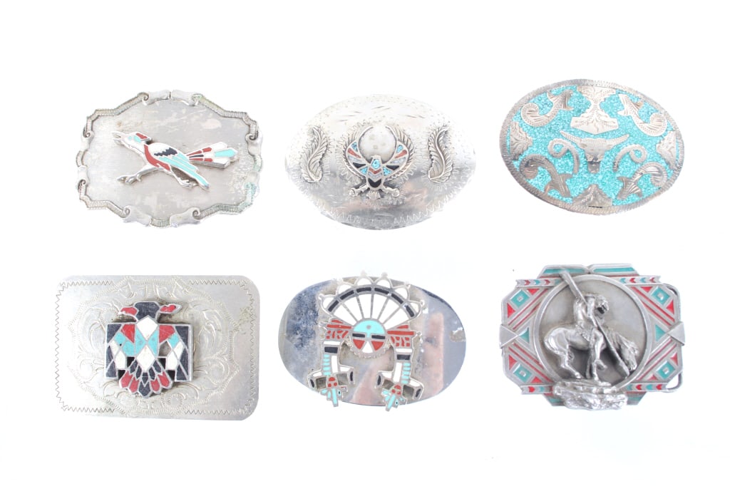 Chipped Multistone Inlaid Buckle Collection: Featured in this lot is this chipped multistone inlaid buckle collection. There are a total of six buckles in this collection. The first buckle is a silver buckle body with a winged eagle that shows c