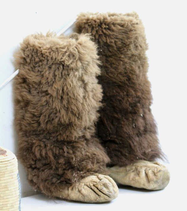 Indian Buffalo Boots or Moccasins: These are made of Buffalo Hide and fur and are sinew sewn. Leather is in good shape and still has flexibility. In great condition. Men's large boots measuring 21" tall with a 11-12" Sole.