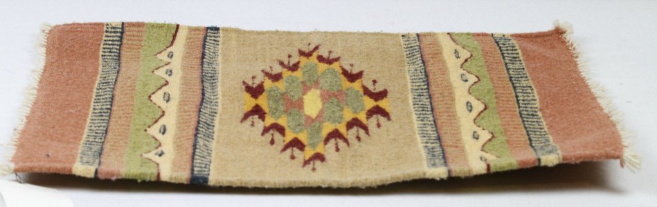 Zapotec Navajo Table Rug: This is made by he Zapotec Indians in in Oaxaca, Mexico. The Zapotec are significant because 400 years ago the Spanish missionaries taught the Navajo and Zapotec how to weave, these practices are stil