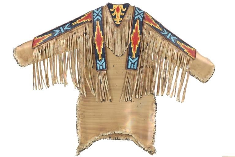 Jay L. Tschudy Lim. Ed. Brass War Shirt Sculpture: Featured in this lot is this beautifully crafted, limited edition (11/125) metal Native American shirt done by renowned Blackfeet artist Jay L. Tschudy circa 2013. Tschudy was born on January 31, 1963