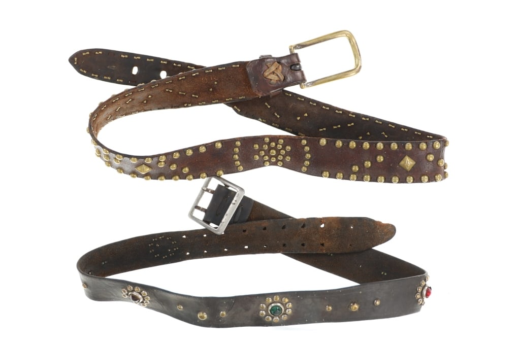 19th C. Cowboy Ornate Brass & Jewel Tacked Belts: The lot features two 19th-century (1800?s) Cowboy belts, one showing ornate brass tacking and the other a jewel design. There are two belts in this collection with the first showing a highly tacked de
