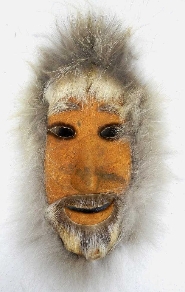 Eskimo Mask: This mask is a work of art made with multiple types of hide and fur. This is a Ceremonial Piece made by the Alaskan Inuit Native Americans. Made of Caribou Rawhide, the edge is Grey Wolf Fur, and the 