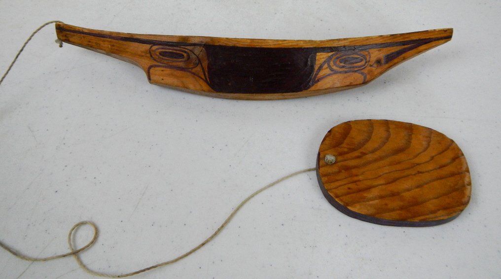 Eskimo Wooden Boat Toy: This is hand made by the Eskimo Native Americans. This is a boat pull along toy with string itact that fatures, hand painted top and sides with Eskimo Designs and a wood boat conected by string to the