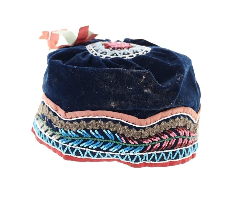 19th-century Haudenosaunee (Iroquois) Beaded Cap: The lot features a Haudenosaunee (Iroquois) beaded cap a classic "Niagara" cap and dating to the late-19th-century. The piece trade clothe with whimsical beadwork in a cap or turban pattern. This hat