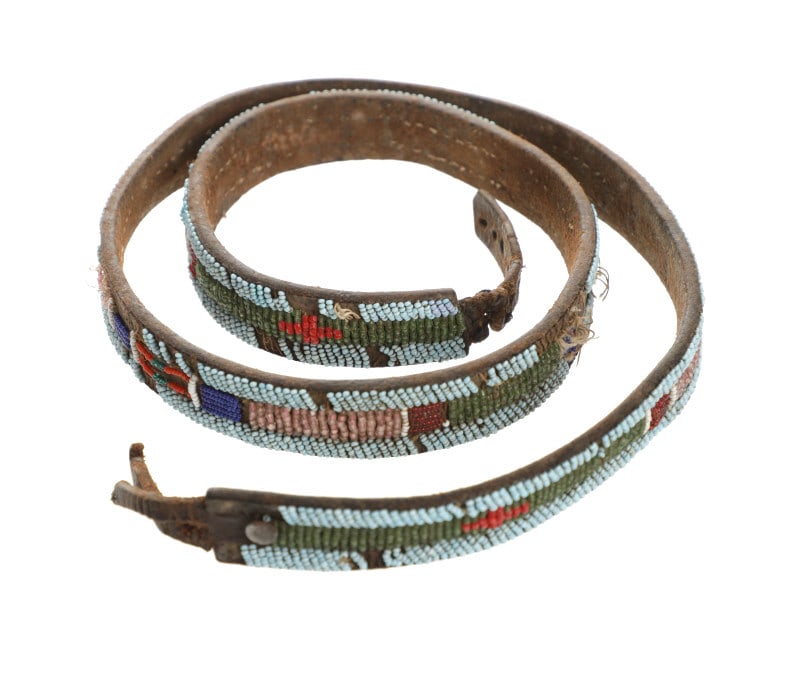 C. 1930's Sioux Beaded Harness Leather Belt: The lot features a harness leather belt with beadwork from the Sioux Indians dating to circa 1930's. The belt is comprised of harness saddlery leather with cotton thread sewn glass trade seed bead ear