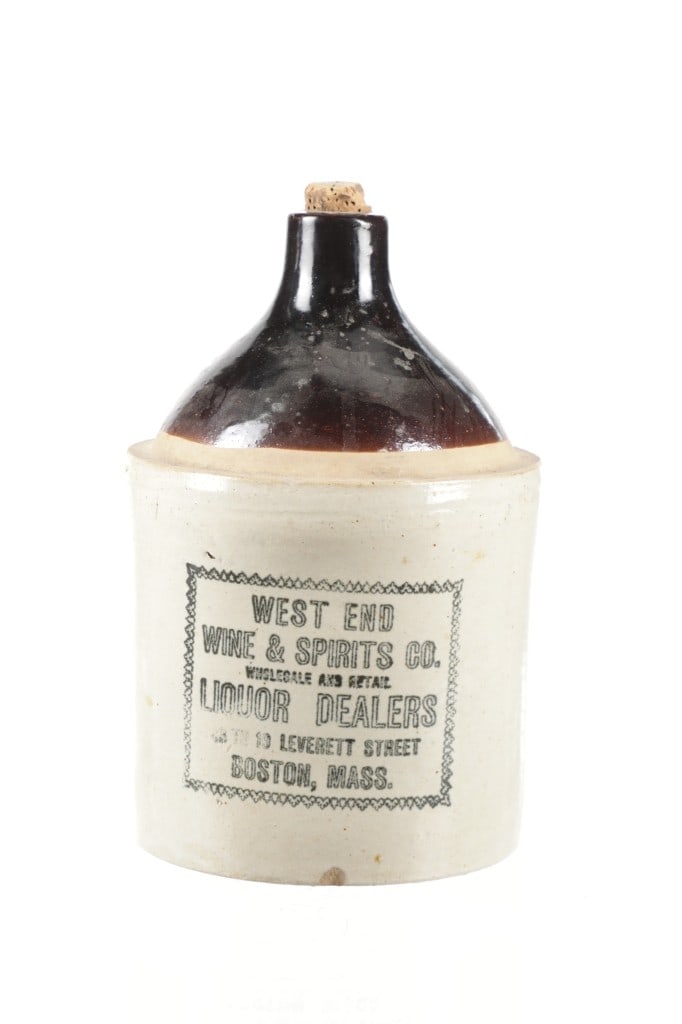 West End Wine & Spirits Co. Whiskey Crock Jug: Featured in this lot is this West End Wine & Spirits Co. whiskey crock jug out of Boston, Mass. The jug features a wonderfully and professionally crafted stoneware construction attributed to Red Wings