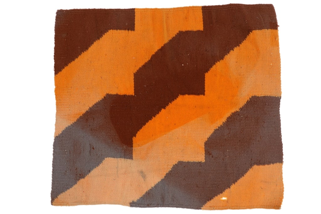Early Vintage Navajo Regional Sampler Throw Rug: This is an unusual early vintage Navajo regional sample throw rug. The rug has an un-banded highly artistic diagonal design with small step in browns, oranges and grays aniline dyes. The rug has a sta