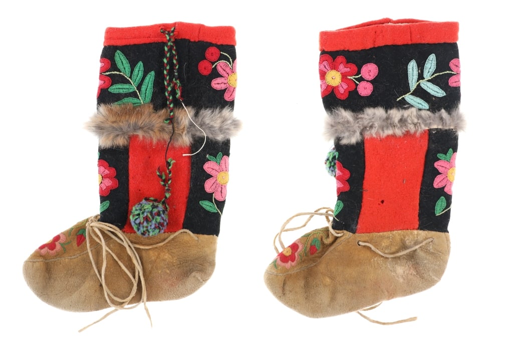 Early Northern Cree Embroidered Moccasins: The lot features a set of high-top moccasins from the Northern Cree of Canada with early-to-mid 1900's age. The set shows Elk Indian tanned hide bottoms with trade clothe tops having a band of fur in 