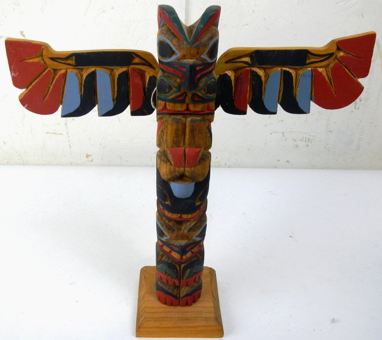 Eskimo Carved Totem Pole: This is a hand carved and painted totem pole craved and signed by Famous Alaskan Eskimo Carver H. Rudick. This is a beautiful piece and measures 12"x12"