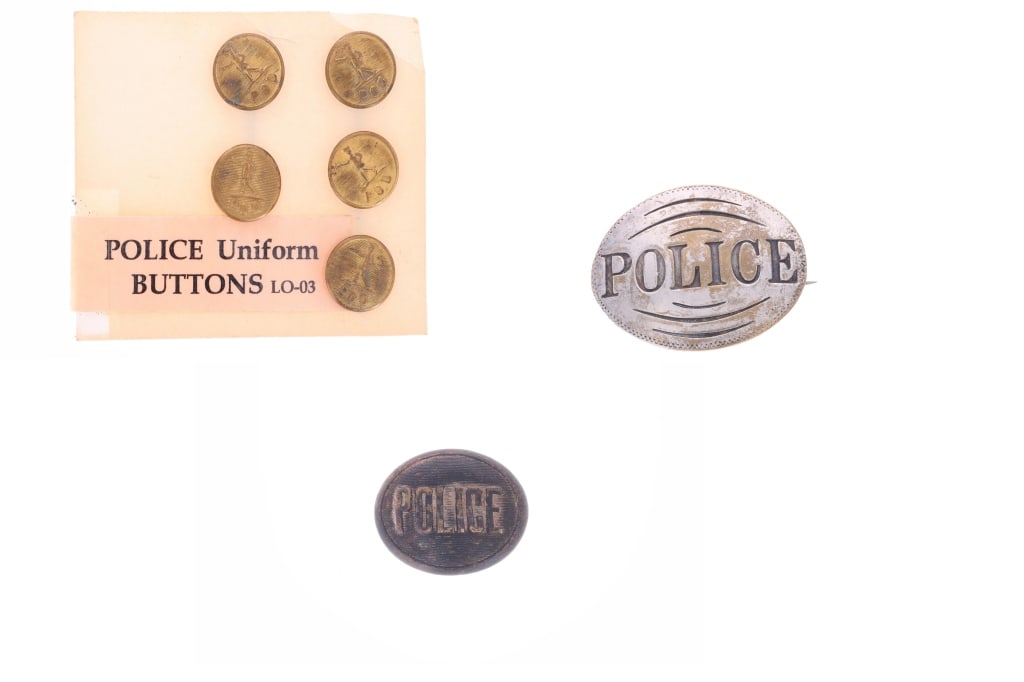 Tombstone Museum Police Badge & Uniform Buttons: Featured in this lot is this collection of police badge and uniform buttons circa 1890 to 1920 and were housed in the Tombstone Western Heritage Museum; Provenance: From the Tombstone Western Heritage