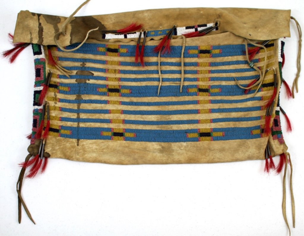 Blackfoot Beaded Bag: This piece features a beadwork pattern all hand tightly beaded by the Blackfoot Native American. This is a nice sized bag and has beadwork strips across the sides and top with a beadwork row pattern a