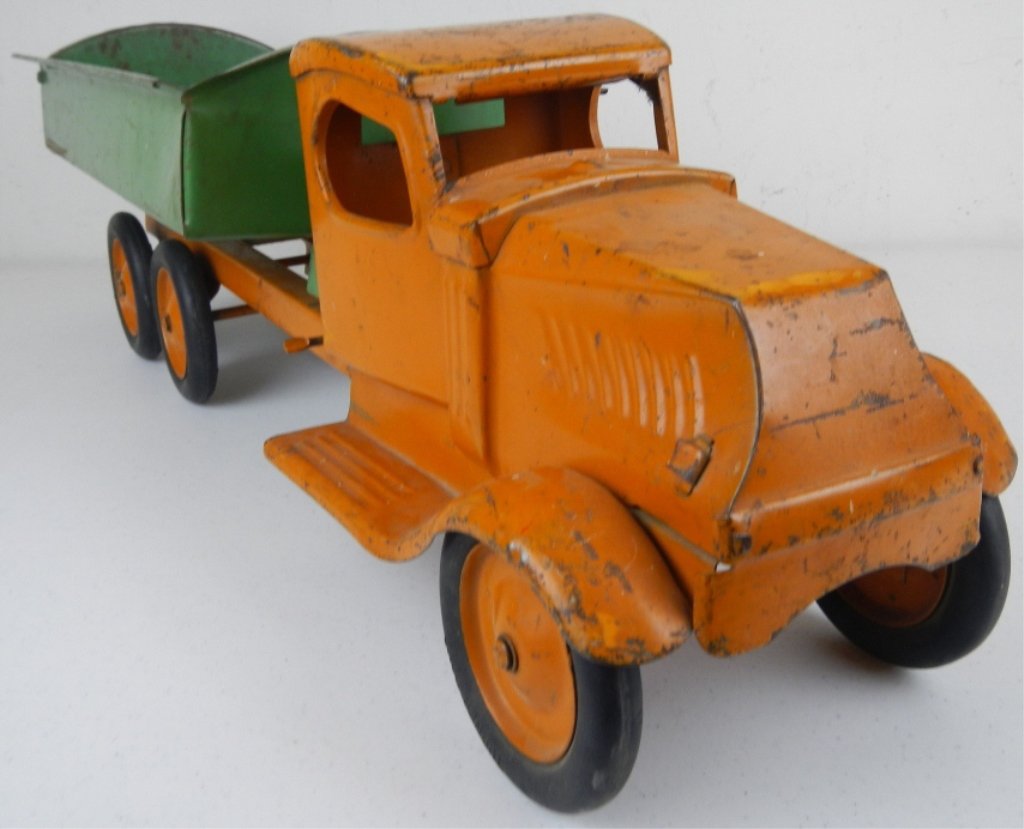 Turner Toy Dump Truck 1930's: This is a 1930's style truck done by the Turner Toy Company and features a working dump and orange and green colors. The dump does have a broken link but does work. Has all the original tires. Measure
