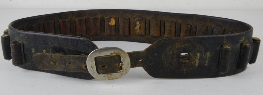 Antique Cowboy Leather Amo Belt with Amo: This is a great old leather belt with worn tooling that measures 39" long. This has 25-20 rounds from Savage, Remington, Winchester, and Western. Great Decor or Western Collectible piece.