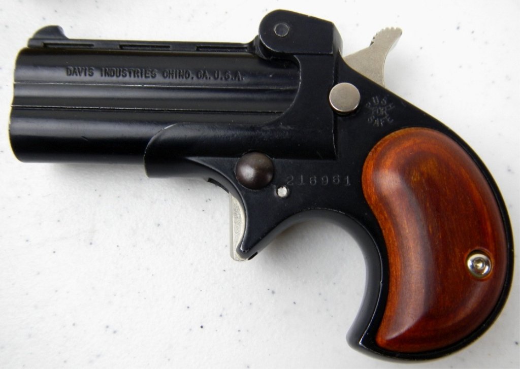 Davis Derringer .22 Mag: This is a Derringer Pistol in the original box made by Davis Industries. This gun takes .22 Magnum caliber rounds and is in working condition. This is a Model DM-22 with a blue finish and serial numbe