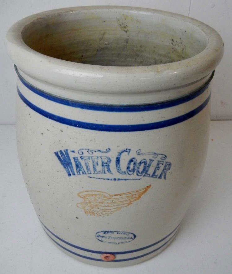 Red Wing Union Stoneware Water Cooler: This is a 5 Gallon Stoneware crock made in Red Wing, Minn. The crock features a beautiful glazed finish with scrolling letters. The bottom of the crock on the inside has a unique and possibly rare gla