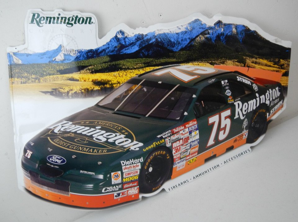 Remington No. 75 Nascar Metal Sign: This is an embossed sign that was made by Remington Arms Company in 1997. This shows their Nascar in front of a Mountain Scene. Great 'Man Cave' item in good condition. Measures 23.5"x31.25"