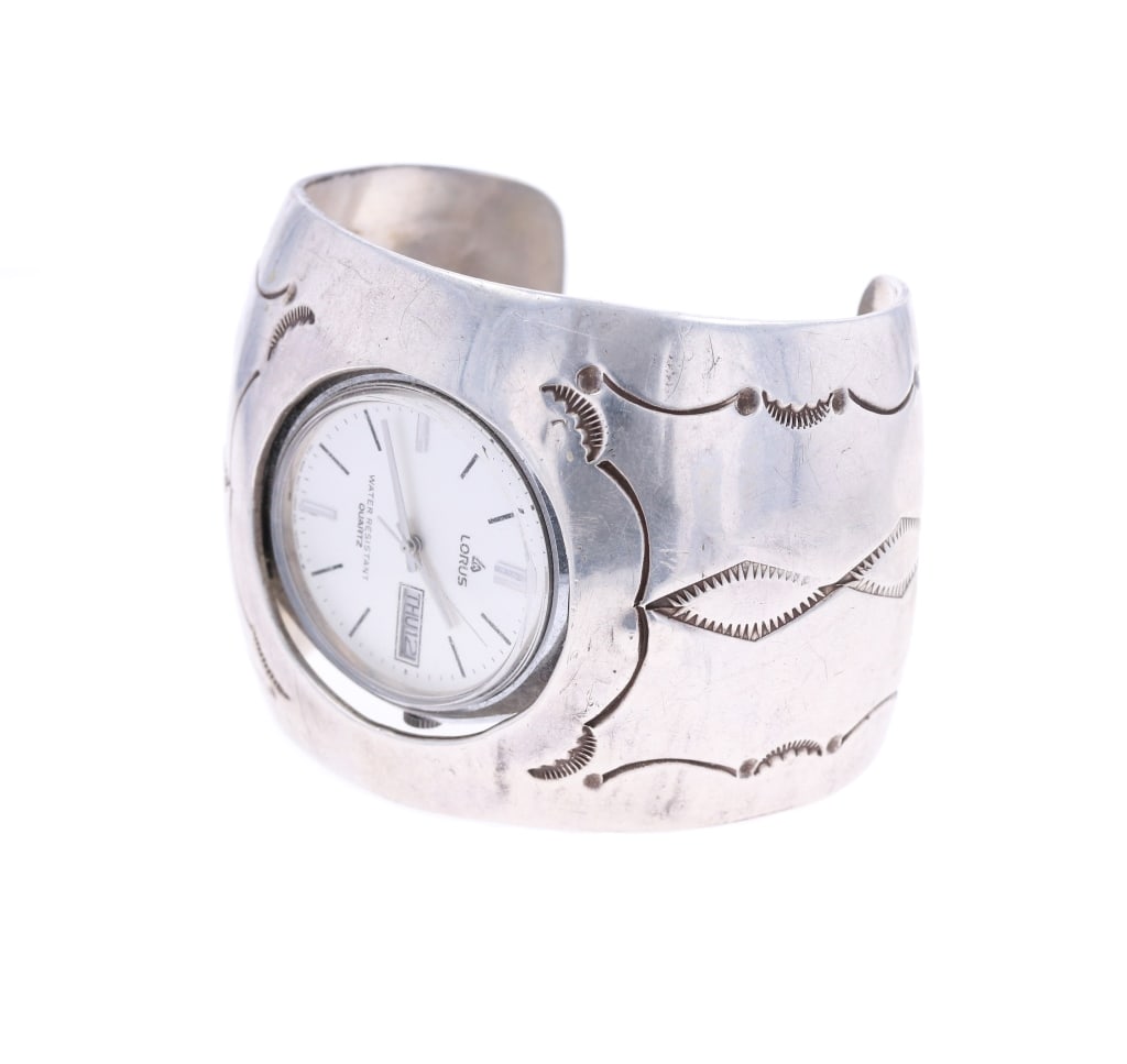 Amazing Large Old Pawn Navajo Sterling Bracelet: The lot features a wonderful old to vintage pawn Navajo sterling silver bracelet cuff with watch insert from the circa 1950-1960's. The watchband features a wonderfully and professionally crafted ster