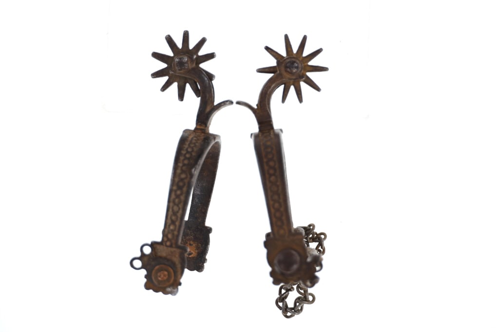 August Buermann Star Drop Shank Spurs c. 1890-10: Featured in this lot is a pair of August Buermann star drop shank spurs circa 1890 to 1910. The spurs are wonderfully and professionally crafted with a ring textured outside frame and the "Peanut Patt