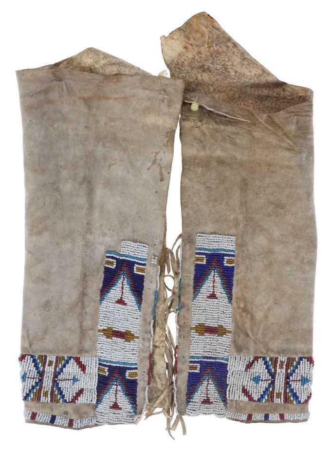 19th Century Lakota Sioux Beaded Hide Leggings: The lot features a set of 19th-century Lakota Sioux beaded Indian hide leggings from a Montana collection. The set is comprised of Indian tanned hide with sinew sewn classic geometric beadwork done in