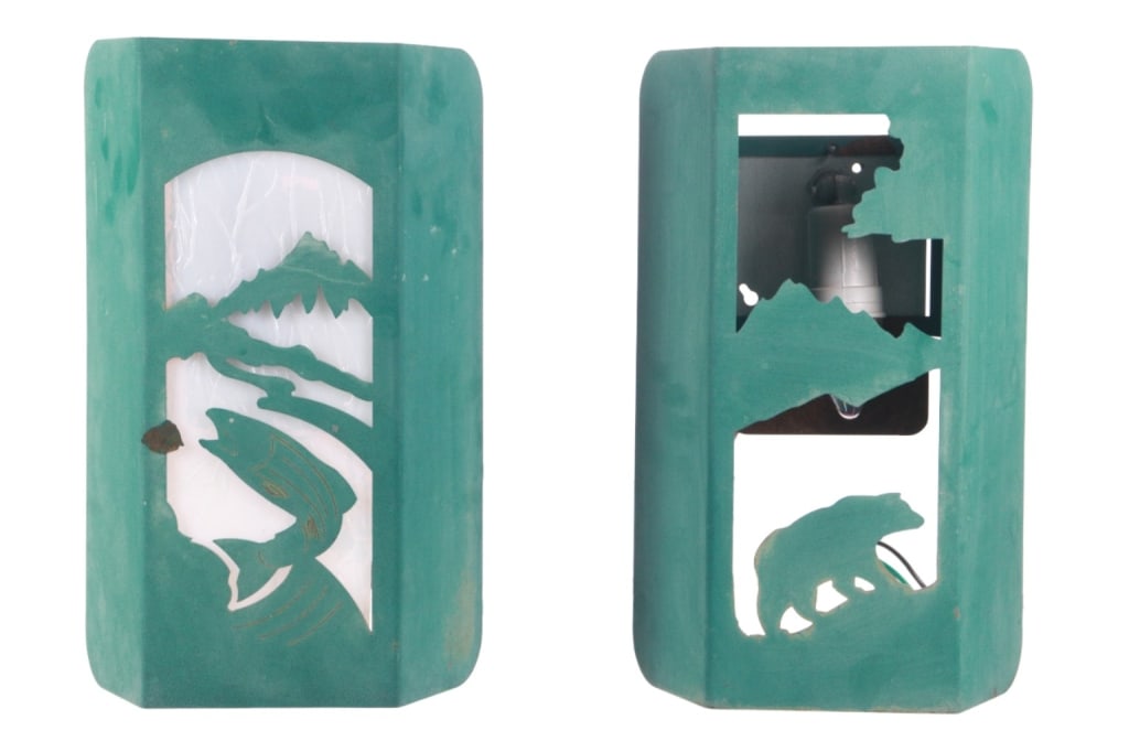 Custom Made Outdoor Wildlife Sconce Lights (2): Featured in this lot are two, custom made outdoor wildlife sconce lights from an Estes Park, Colorado estate in 2005. These lights feature a metal construction showing a green color and feature a text