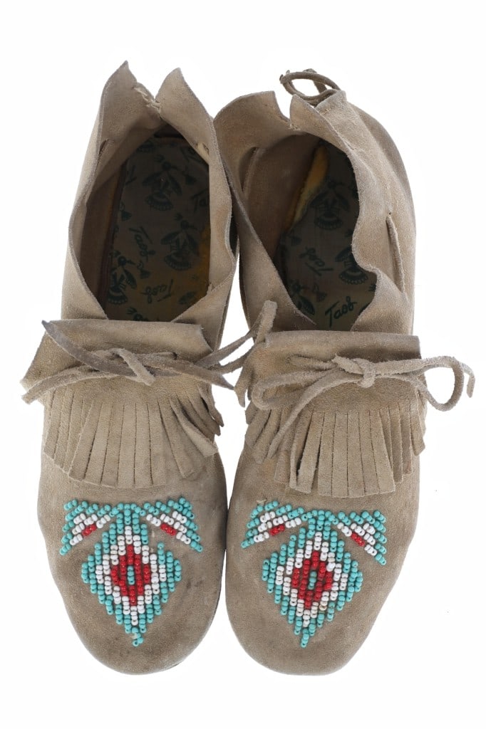 Vintage Montana Blackfoot Beaded Moccasins: The lot features a set of hide beaded mcocasins from the Blackfoot / Blackfeet of Montana with a nice vintage age from the 20th-century. The moccasins show a foot worn patina on the bottom with thread