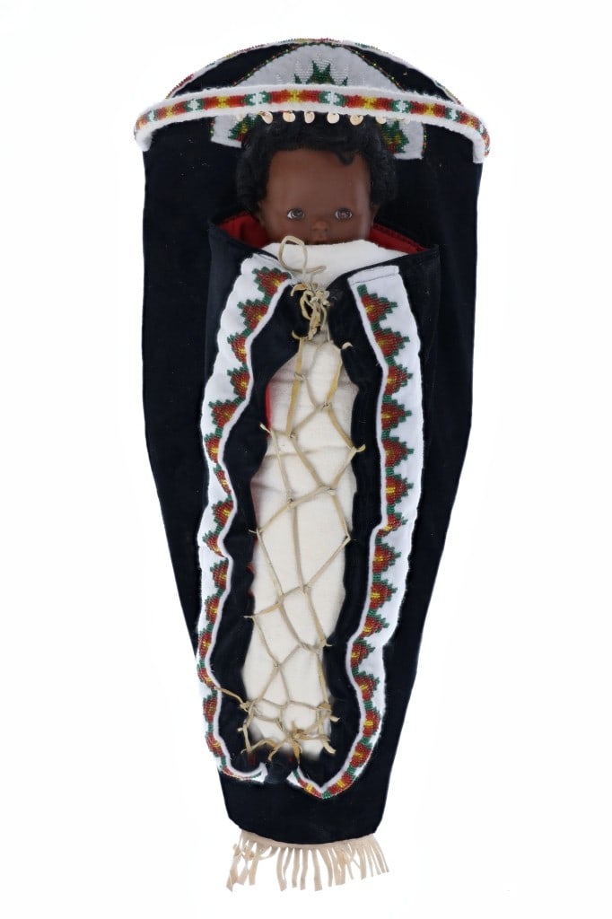 Northern Cree Beaded Full Size Cradleboard: The lot features a full size, large cradleboard papoose with nice beadwork from the Northern Cree of Canada from the 20th-century. The cradle board shows a solid base with hoop wrapped in clothe and a