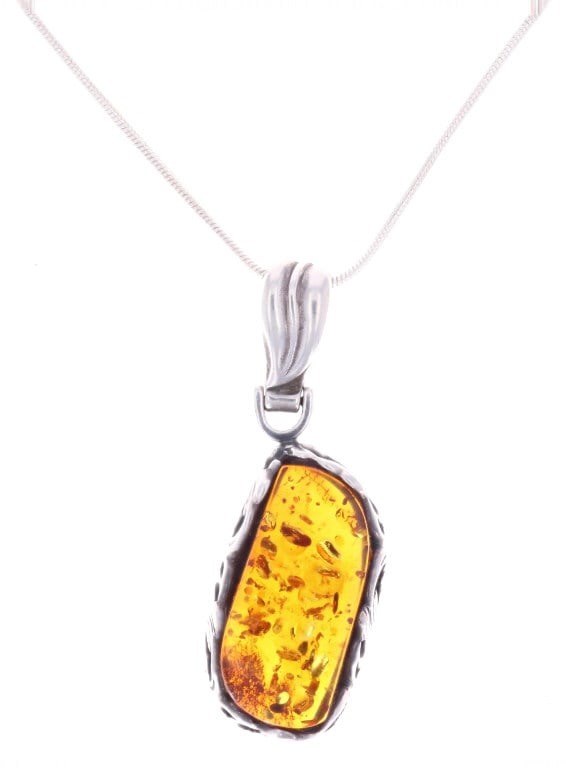Natural Amber Sterling Silver Necklace c. 1960s: Featured in this lot is this natural amber sterling silver necklace circa 1960s. The necklace features a wonderfully and professionally crafted sterling silver and amber construction that shows a natu